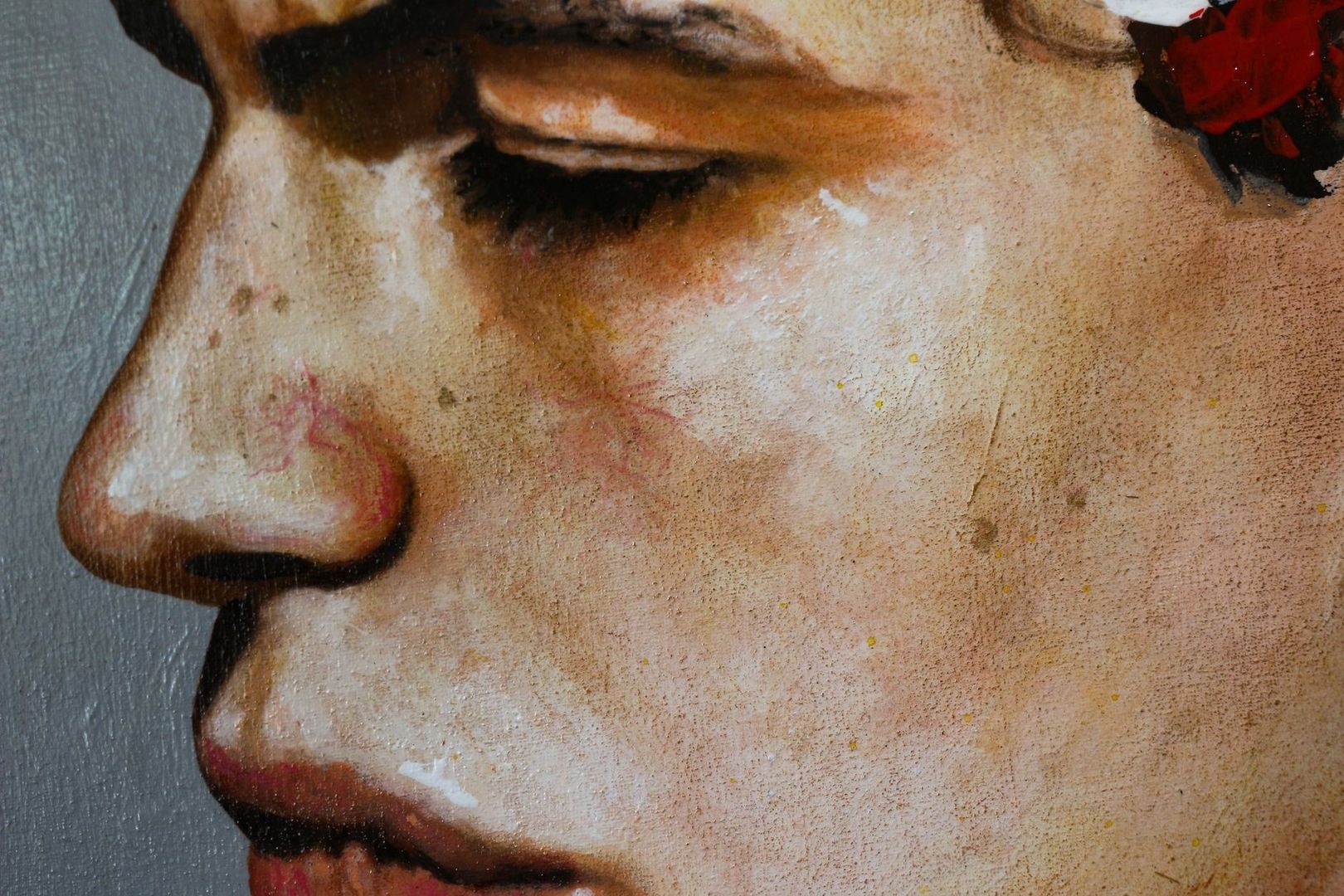 Close-up painted face showing strong light and shadow across the eyes